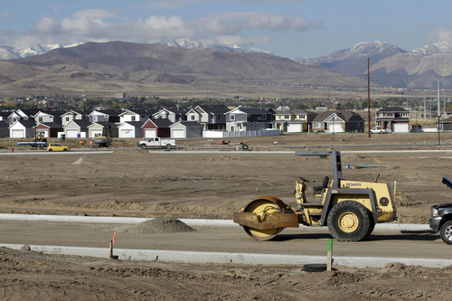 Al Hartmann  |  The Salt Lake Tribune
A new housing subdivision development rises between I-15 and the Jordan River in Bluffdale Oct. 15, 2013. The city is keeping pace with housing demands but wants to develop an 80-acre private-property parcel along Redwood Road north of the NSA Utah Data Center into a commercial business center for the growing area.