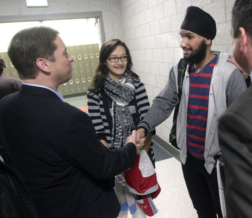 Al Hartmann  |  The Salt Lake Tribune
State Senator Aaron Osmond, left, shakes hands with Granite High School Academic President Vivian Nguyen and Student Body President Maninderjit Singh during a tour of Granger High School in West Valley City Monday November 4.   Several Utah legislators and Granite School District officials visited to observe the learning environment in the school, to identify areas for improvement and to work on solutions. Utah's new School Grading evaluation gave Granger High Schools a D.