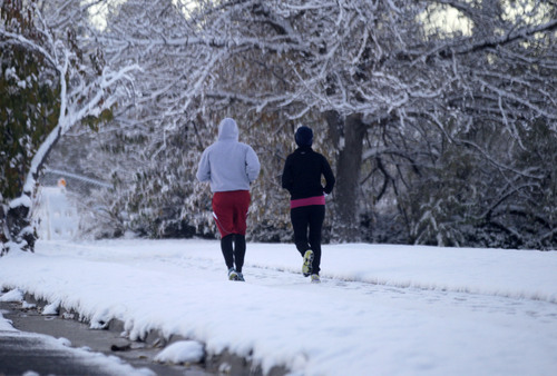 Al Hartmann  |  The Salt Lake Tribune
Runners get their first taste of winter at Sugar House Park on Tuesday morning after a couple of inches of snow fell overnight.