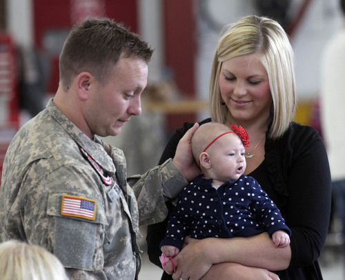 Al Hartmann  |  The Salt Lake Tribune
Utah Army National Guardsman Chief Warrant Officer 2 Christopher Ryan  says goodbye to his wife Melissa Ryan and baby Brynlee at the Guard's Army Aviation Support facility in West jordan Tuesday Nov. 5, 2013. He is a helicopter pilot and is among 22 soldiers of the Utah Army National Guard Medevac unit leaving on a 12-month deployment to Afghanistan. The Guard's Detachment 2, Charlie Company, 1-171st Aviation said goodbye to friends and family in a departure ceremony. They will spend time at Fort Hood, Texas, for several weeks of training for the deployment. Their mission will be to provide medical evacuation and airlifts for coalition forces in Afghanistan.