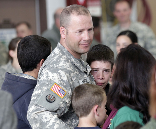 Al Hartmann  |  The Salt Lake Tribune
Utah Army National Guardsman Chief Warrant Officer 3 Andrew Lovejoy gets a group hugs from his wife and children at the Guard's Army Aviation Support facility in West Jordan Tuesday Nov. 5, 2013. He is among 22 soldiers of the Utah Army National Guard Medevac unit leaving on a 12-month deployment to Afghanistan. The Guardís Detachment 2, Charlie Company, 1-171st Aviation said goodbye to friends and family in a departure ceremony. They will spend time at Fort Hood, Texas, for several weeks of training for the deployment. Their mission will be to provide medical evacuation and airlifts for coalition forces in Afghanistan.
