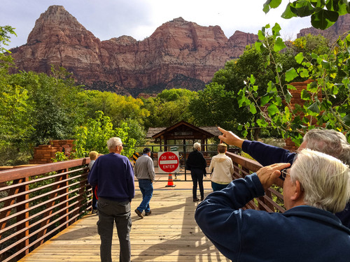 Trent Nelson  |  The Salt Lake Tribune
Tourists point out landmarks visible from the closed gate to Zion National Park, which remains closed due to the government shutdown, Wednesday, October 9, 2013.