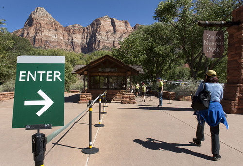 Steve Griffin  |  The Salt Lake Tribune

Park goers use the walk in entrance to Zion National Park  near Springdale, Utah Monday, September 30, 2013. A looming federal government shutdown could close all National Parks.