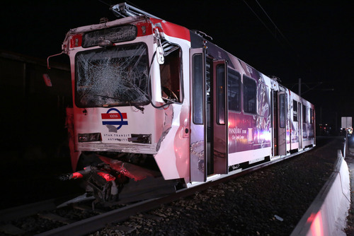 Francisco Kjolseth  |  The Salt Lake Tribune
A North bound TRAX train who's last car unbuckled and sat still on the track near 8000 South and State Street in Midvale sits on the track after being rear ended by another North bound train train on Tuesday night, Nov. 5, 2013. The driver of the second train moving up the line a short while later was able to slow down but not avoid the collision.