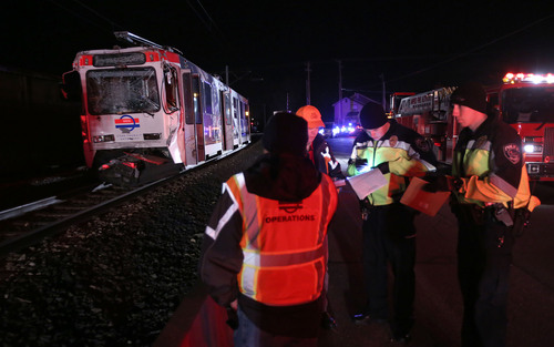 Francisco Kjolseth  |  The Salt Lake Tribune
A North bound TRAX train who's last car unbuckled and sat still on the track near 8000 South and State Street in Midvale lies crushed after being rear ended by another North bound train train on Tuesday night, Nov. 5, 2013. The driver of the second train moving up the line a short while later was able to slow down but not avoid the collision.