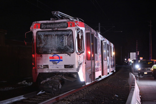 Francisco Kjolseth  |  The Salt Lake Tribune
A North bound TRAX train who's last car unbuckled and sat still on the track near 8000 South and State Street in Midvale lies crushed after being rear ended by another North bound train train on Tuesday night, Nov. 5, 2013. The driver of the second train moving up the line a short while later was able to slow down but not avoid the collision.