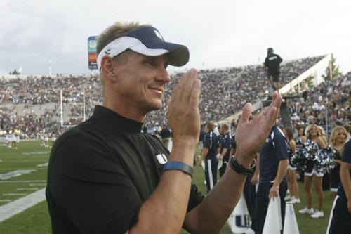 Tribune file photo 

Aggie head coach Gary Andersen cheers as his team takes the field for the game against BYU in Provo in September.