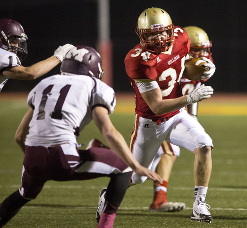 Lennie Mahler  |  The Salt Lake Tribune
Judge Memorial's Max Barnett rushes the ball defended by Morgan's Matt Murdock on Friday, Oct. 25, 2013, in Salt Lake City. Judge defeated Morgan 28-14 to clinch the regional title.