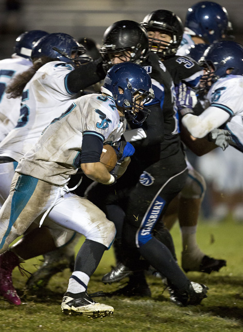 Lennie Mahler  |  The Salt Lake Tribune
Juan Diego's Chase Williams rushes the ball against Stansbury on Thursday, Oct. 10, 2013.