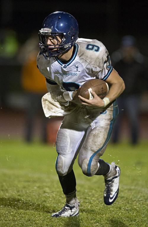 Lennie Mahler  |  The Salt Lake Tribune
Juan Diego quarterback Cole Nelson runs the ball after recovering a fumble on a snap against Stansbury Thursday, Oct. 10, 2013.