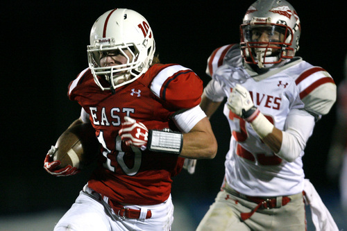 Chris Detrick  |  The Salt Lake Tribune
East's Preston Curtis (10) runs past Bountiful's Brady Litz (23) for a touchdown during the game at East High School Thursday October 17, 2013. East is winning the game 42-7 in the third quarter.