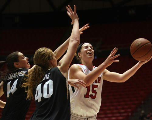 Kim Raff | The Salt Lake Tribune
University of Utah player (right) Michelle Plouffe drives the basket past Colorado player (left) Meagan Malcolm-Peck and (middle) Rachel Hargis during a game at the Huntsman Center in Salt Lake City on January 13, 2013. Utah lost the game 43-56.
