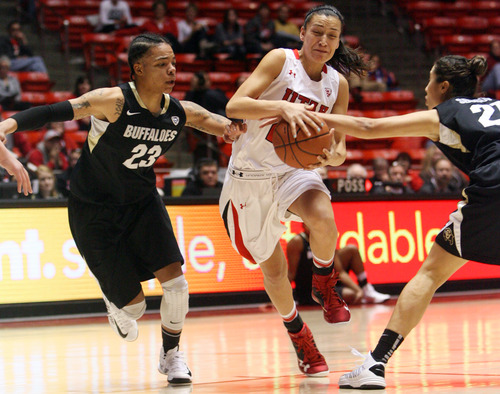 Kim Raff | The Salt Lake Tribune
University of Utah player (middle) Danielle Rodriguez drives the basket past Colorado player (left) Chucky Jeffery and (right) Chelsea Bridgewater during a game at the Huntsman Center in Salt Lake City on January 13, 2013. Utah lost the game 43-56.