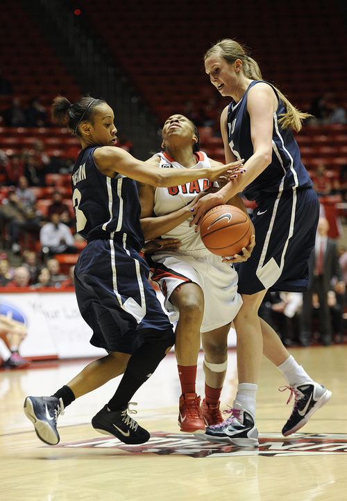 Sarah A. Miller  |  The Salt Lake Tribune

Utah's Janita Badon is stopped by BYU's Jazmine Foreman, left, and Jennifer Hamson, right, in the first period at the Huntsman Center in Salt Lake City Saturday February 12, 2011.
