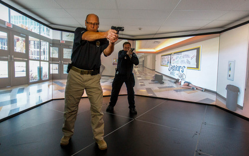 Trent Nelson  |  The Salt Lake Tribune
Unified Police Deputy Chief Shane Hudson and Range Master Nick Roberts run through a school shooting simulation while demonstrating a new five-screen training simulator used to put officers through realistic situations in Salt Lake City, Thursday November 7, 2013.
