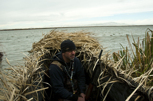 Chris Detrick  |  The Salt Lake Tribune 
Carl Taylor waits in his boat while duck hunting with his dog JB in Farmington Bay in 2010.