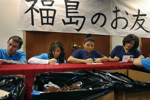 Scott Sommerdorf   |  The Salt Lake Tribune
Stevens-Henager College respiratory therapy students prepare notes to send along with 179 hand-knitted scarves they boxed up, foreground, to be sent to children in Japan who were orphaned or displaced by the 2011 tsunami and nuclear disaster in Fukushima.