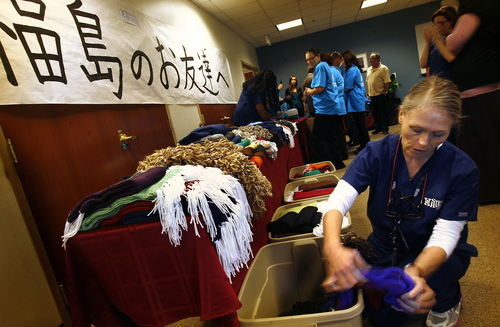 Scott Sommerdorf   |  The Salt Lake Tribune
Stevens-Henager College respiratory therapy student Shellie Howard helps display some of the 179 hand-knitted scarves to be sent to children in Japan who were orphaned or displaced by the 2011 tsunami and nuclear disaster in Fukushima.
