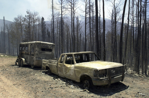 7/1702
Grayson West/ Salt Lake Tribune

The chared remains of a truck, the victim of the wild fire burning in the Uintas near Evanston has claim more than 5800 acres and is only five percent contained as of Monday morning.