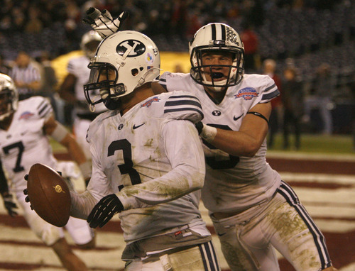 Rick Egan  | The Salt Lake Tribune 

Brigham Young Cougars defensive back Daniel Sorensen (9) celebrates with Brigham Young linebacker Kyle Van Noy (3) after he scores a touchdown for cougars, on an intercepted pass, as BYU defeated San Diego State 23-6 in the Poinsettia Bowl, Thursday, December 20, 2012.