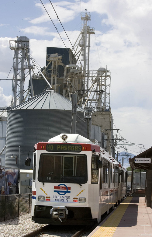 Paul Fraughton  |   Tribune file photo
A Utah Transit Authority Trax train rolls past grain storage in this photo from 2013.