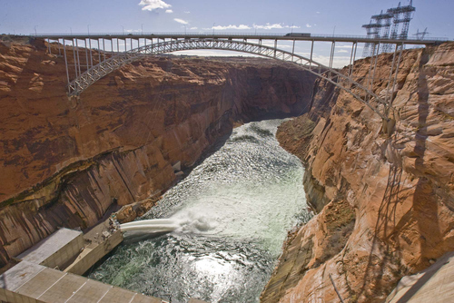 Paul Fraughton  |  Tribune file photo
Authorities are again releasing high flows from Glen Canyon Dam, shown in 2008 with a similar release, to distribute sediment piled up below the dam.