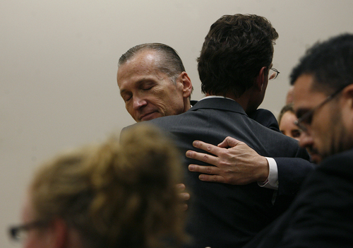Scott Sommerdorf   |  The Salt Lake Tribune
Martin MacNeill hugs attorney Randy Spencer as he thanks his defense team after he was found guilty of murder and obstruction of justice early Saturday morning, November 9, 2013.