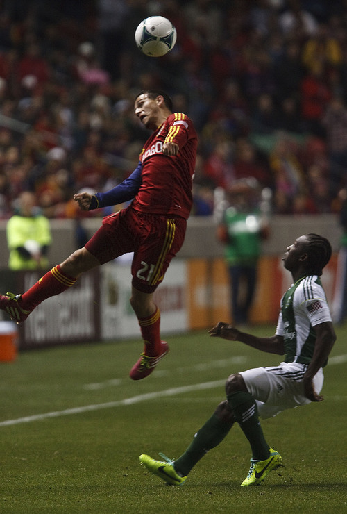 Leah Hogsten  |  The Salt Lake Tribune
Real Salt Lake midfielder Luis Gil (21) takes a header over Portland Timbers midfielder Diego Chara (21). Real Salt Lake leads the Portland Timbers 1-0 at the half during their first leg of  the Western Conference final series Sunday, November 10, 2013 at Rio Tinto Stadium.