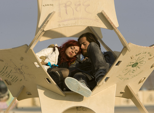 Rick Egan  | The Salt Lake Tribune 

Katie and Jacob Anderson, Redondo Beach, Calif., cuddle in a pod near the Temple of Whollyness during the annual Burning Man Festival in the Black Rock Desert, Nev., Friday, August 30, 2013.