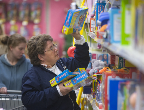 Joyce Gofff shops for toys for her grandchildren at the Wal-Mart Supercenter at 9151 S. Quarry Rd in Sandy Friday morning.  She figured that she would spend about the same this Christmas.  "I won't overdue it, she said.   Al Hartmann photo/Salt Lake Tribune    11/28/08