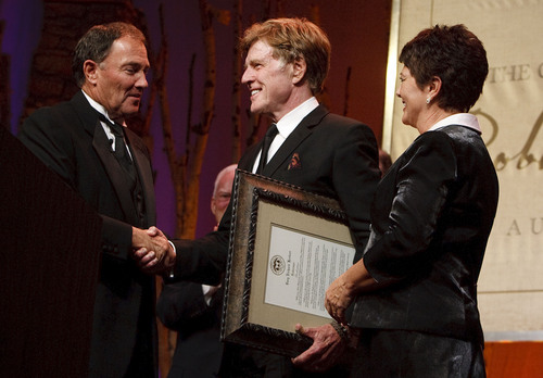 Leah Hogsten  |  The Salt Lake Tribune
Gov. Gary Herbert and his wife, Jeanette, present Robert Redford with the declaration that November 9, 2013 is Robert Redford Day. For all his contributions to the state of Utah, Robert Redford was recognized and honored by Governor Gary Herbert at a gala in his honor, "The Governor's Salute to Robert Redford: A Utah Tribute to an American Icon" at the Grand America Hotel, Saturday, November 9, 2013. Redford is an actor, director, producer, philanthropist, businessman, environmentalist, and founder of the Sundance Resort, the Sundance catalog, and the Sundance Institute which hosts the Sundance Film Festival.