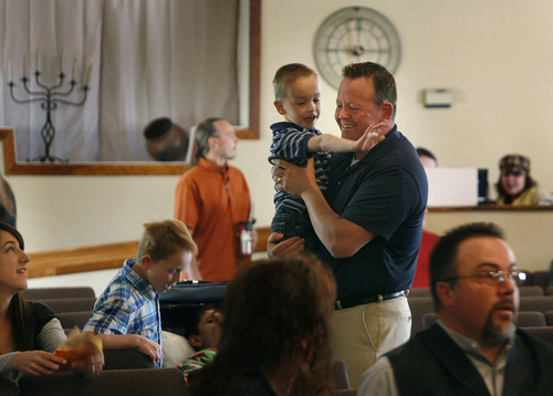 Scott Sommerdorf   |  The Salt Lake Tribune
Former Utah lawmaker Carl Wimmer holds his youngest son, Reagan, 6, as his 9-year-old son, Heston, stands next to his wife, Sherry, seated at far left just before Sunday services at Ephraim Church of the Bible on Sunday, Oct. 27, 2013.
