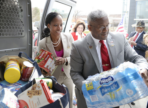 Al Hartmann  |  The Salt Lake Tribune
Mia Love and former Congressman Allen West load donated food items to be delivered to Fisher House,  a home for family's of veterans undergoing healthcare at Salt Lake City's VA Hospital.  Earlier she held a town hall meeting with West.