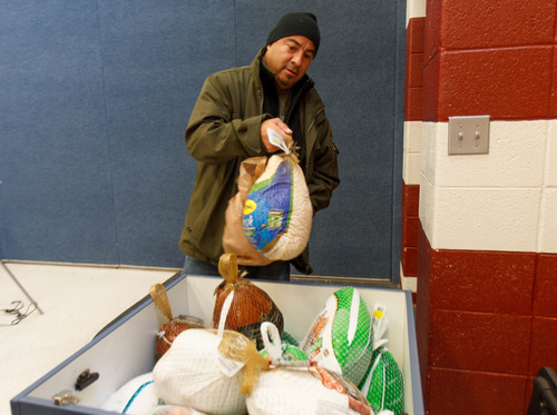 Trent Nelson  |  The Salt Lake Tribune
Frank Bedolla drops off a turkey at the 13th Annual Latino Community Turkey Drive on Nov. 17, 2012. The Salt Lake Tribune has begun to compile a list of businesses and nonprofit organizations collecting food, clothing and gifts for distribution to the needy this holiday season.