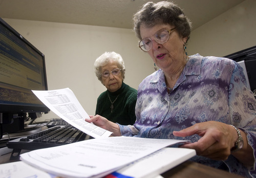 Tribune File Photo
Vicki Nelson, right, a volunteer Medicare counselor for Salt Lake County Aging Services, goes over Teddy Garrick's Medicare plan at the Harmon Senior Center in West Valley City. Recent changes to Medicare are limiting plan choices and removing some doctors from plans.
