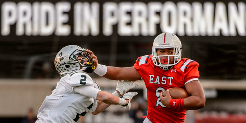 Trent Nelson  |  The Salt Lake Tribune
East's Ula Tolutau stiff-arms Olympus's Connor Haller as East defeats Olympus High School in the 4A State Semifinals in Salt Lake City, Thursday November 14, 2013.