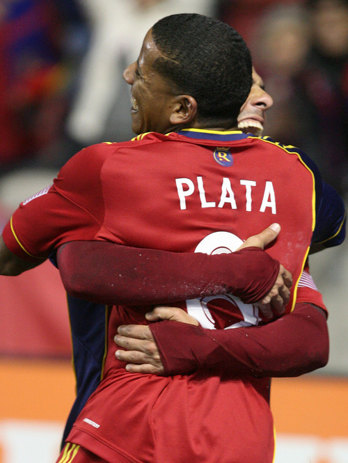 Leah Hogsten  | The Salt Lake Tribune
Real Salt Lake midfielder Javier Morales (11) who headed the ball from teammate Real Salt Lake forward Jou Plata (8)celebrate the goal. Real Salt Lake defeated the Portland Timbers 4-2  during their first leg of the Western Conference final series Sunday, November 10, 2013 at Rio Tinto Stadium.