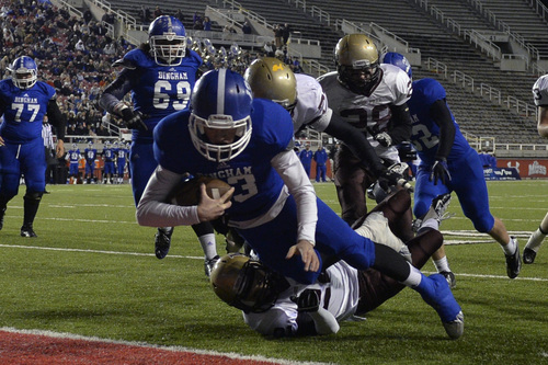 Chris Detrick  |  The Salt Lake Tribune
Bingham's Kyle Gearig (13) scores a touchdown past Lone Peak's Chase Armstrong (22) and Lone Peak's Josh Southwick (77) during the 5A semifinal game at Rice-Eccles Stadium Friday November 15, 2013.