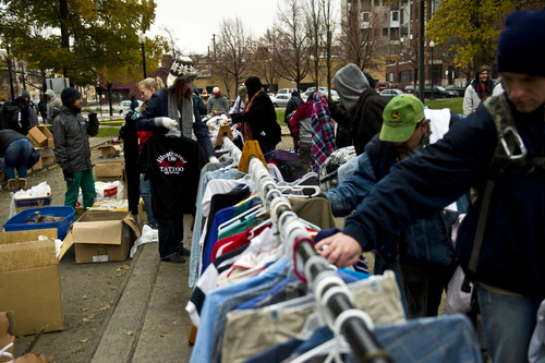 Chris Detrick  |  The Salt Lake Tribune
People look through racks of free clothes Saturday in Pioneer Park, where a nonprofit group, The Legacy Initiative, continued its homeless outreach with a "Street Boutique" and deliveries of homemade bean-and-cheese burritos.