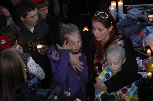 Francisco Kjolseth  |  The Salt Lake Tribune
CharlÈ Meier comforts her two daughters Kendyll Stewart, left, and Ariyl Meier as they are surrounded by people gathered in South Jordan at Firmont Park for a candelight vigil on Sunday, Nov. 17, 2013, in memory of her son Taylor Wheeler, 12, and Dayton Gessell, 15, after the two were found dead in a home in Daybreak on Friday.