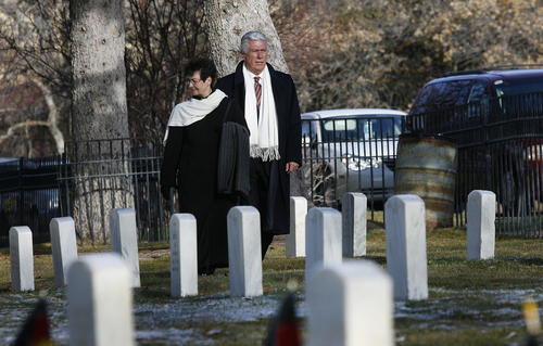 Scott Sommerdorf   |  The Salt Lake Tribune
President Dieter F. Uchtdorf, a fighter pilot in the postwar German Air Force and second counselor in the LDS Church's First Presidency, and his wife, Harrie,t visit the graves of nine German soldiers in a southeast section of the Fort Douglas Cemetery. The soldiers, along with others from WW I and some Italian, and Japanese soldiers from WW II, were honored during the ceremony on the German Day of Remembrance Sunda,y November 17, 2013.