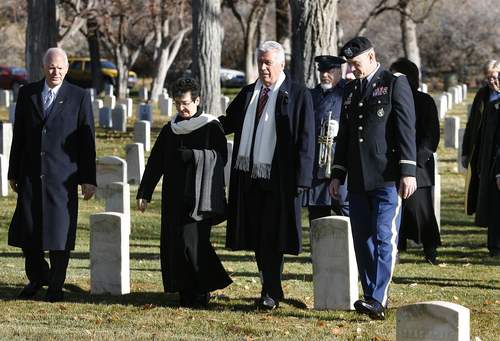 Scott Sommerdorf   |   The Salt Lake Tribune
President Dieter F. Uchtdorf of the LDS Church's First Presidency and his wife, Harriet, along with Honorary Consul Charles W. Dahlquist, left, and Col. Sanford Atrman, right, visit the graves of nine German soldiers in a southeast section of the Fort Douglas Cemetery on Sunday. The soldiers, along with others from WW I and some Italian and Japanese soldiers from WWII, were honored during the ceremony on the German Day of Remembrance, Sunday November 17, 2013.