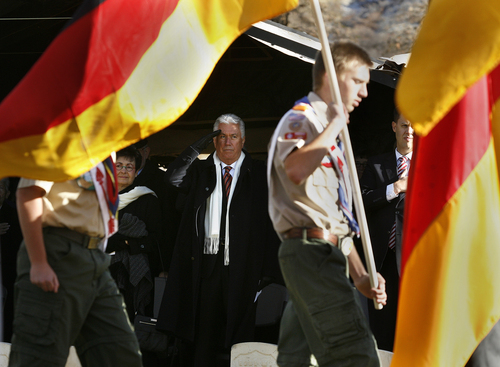 Scott Sommerdorf   |  The Salt Lake Tribune
President Dieter F. Uchtdorf, a fighter pilot in the postwar German Air Force and second counselor in the LDS Church's First Presidency, salutes as a Boy Scout color guard brings in German and American flags during the ceremony on the German Day of Remembrance Sunday November 17, 2013. Nine German soldiers buried in a southeast section of the Fort Douglas Cemetery were honored, along with about 20 other German soldiers buried there from World War I.
