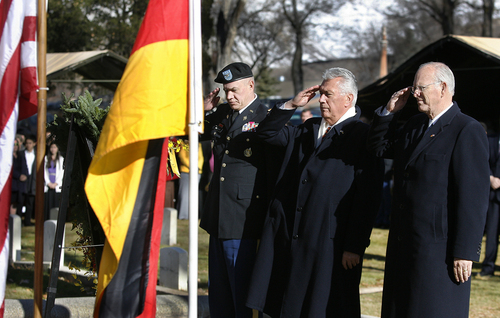 Scott Sommerdorf   |   The Salt Lake Tribune
President Dieter F. Uchtdorf, center, of the LDS Church's First Presidency, along with Col. Sanford Atrman, left, and Honorary German Consul Charles W. Dahlquist, right, salute during the ceremony at Fort Douglas Cemetery on the German Day of Remembrance, Sunday November 17, 2013.
