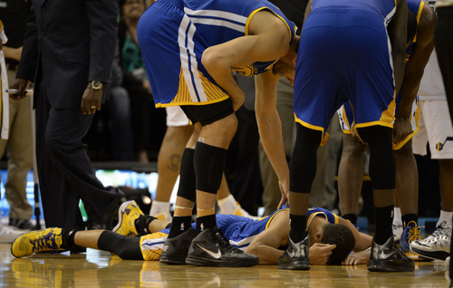 Rick Egan  | The Salt Lake Tribune 

Golden State Warriors point guard Stephen Curry (30) is slow to his feet, after colliding with Utah Jazz power forward Marvin Williams (2), in NBA action, The Utah Jazz vs. The Golden State Warriors, at the EnergySolutions Arena, Monday, November 18, 2013.  Curry did not return to the game after the play.