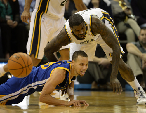 Rick Egan  | The Salt Lake Tribune 

Utah Jazz power forward Marvin Williams (2) stumbles on top of Golden State Warriors point guard Stephen Curry (30), in NBA action, The Utah Jazz vs. The Golden State Warriors, at the EnergySolutions Arena, Monday, November 18, 2013.  Curry did not return to the game after the play.