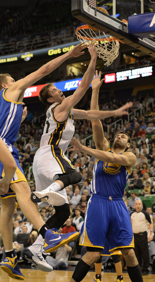 Rick Egan  | The Salt Lake Tribune 

Utah Jazz shooting guard Gordon Hayward (20)goes to the hoop, as The Utah Jazz faced The Golden State Warriors, at the EnergySolutions Arena, Monday, November 18, 2013.  Curry did not return to the game after the play.