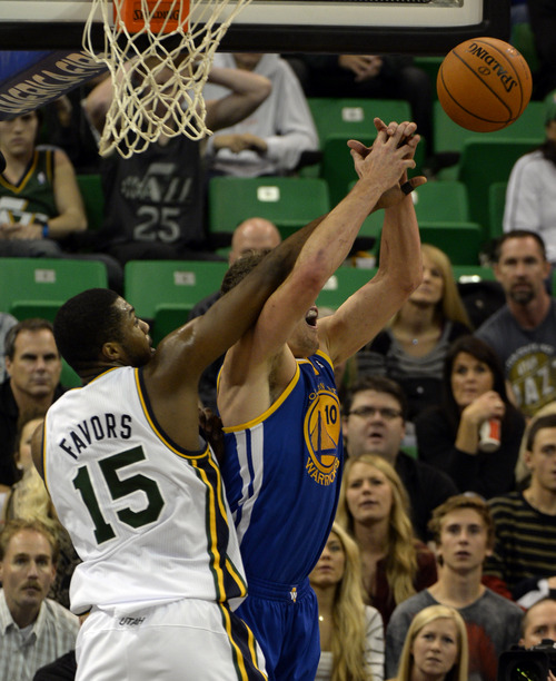 Rick Egan  | The Salt Lake Tribune 

Utah Jazz power forward Derrick Favors (15) fouls Golden State Warriors power forward David Lee (10) as The Utah Jazz faced The Golden State Warriors, at the EnergySolutions Arena, Monday, November 18, 2013.  Curry did not return to the game after the play.
