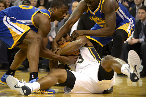 Rick Egan  | The Salt Lake Tribune 

Utah Jazz small forward Mike Harris (33) wrestles for control of the ball, with Golden State Warriors small forward Harrison Barnes (40) and Draymond Green (23) as The Utah Jazz faced The Golden State Warriors, at the EnergySolutions Arena, Monday, November 18, 2013.  Curry did not return to the game after the play.