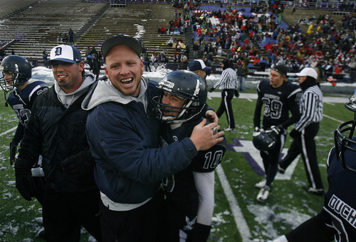 Scott Sommerdorf   |  The Salt Lake Tribune
Duchesne head coach Jerry Cowan, hugs RB Matt Muir as the teams rushes the field after their win over Rich. Duchesne defeated Rich 14-13 to win the 1A state championship, played at Weber State University in Ogden, Utah, Saturday November 16, 2013..